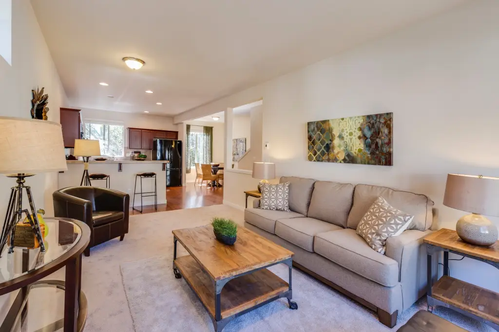 Furnished living room with a sofa, coffee table and open-plan kitchen