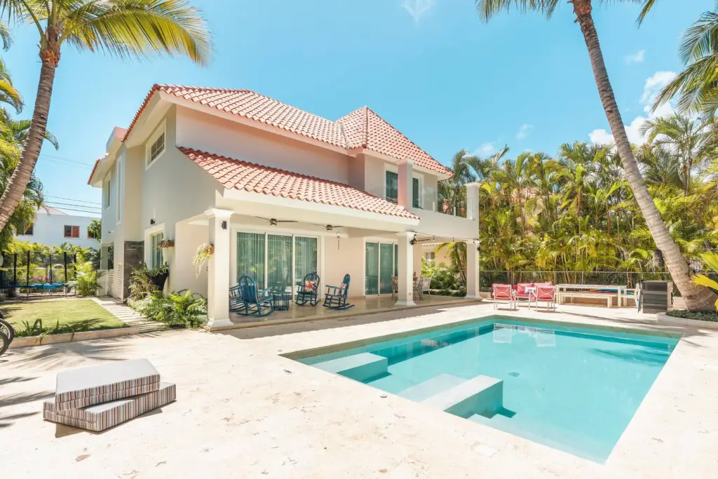 Two-story villa with a private pool and palm trees in Punta Cana, Dominican Republic